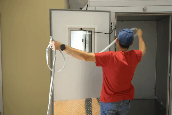Technician fitting a replacement gasket to a walk-in cooler door